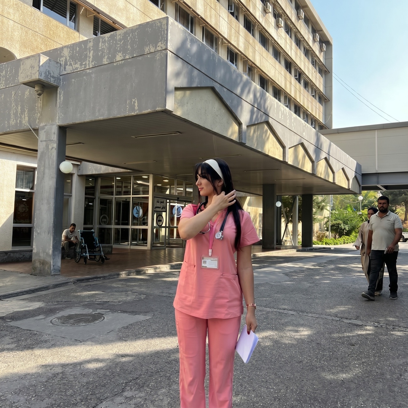 Dr. Noorain Mohammed Assim, in pink scrubs at the University of Duhok hospital